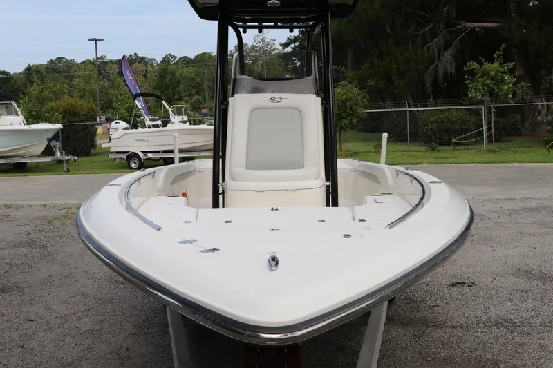 Slide: The Image of 2018 ShearWater 25 LTZ boat displayed outdoors, showcasing sleek design and spacious deck. - 2