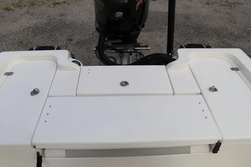 Slide: The Image of 2018 ShearWater 25 LTZ boat stern with motor and storage compartments. - 8