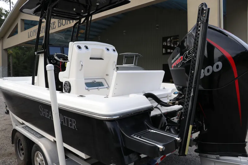 Slide: The Image of 2018 ShearWater 25 LTZ boat with powerful engine, parked on a trailer. - 5