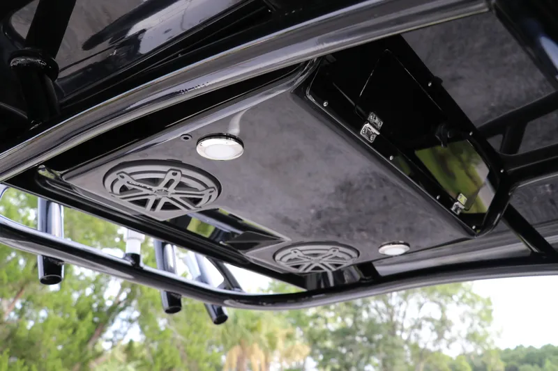 Slide: The Image of 2018 ShearWater 25 LTZ boat's sleek black T-top with integrated speakers and lighting. - 21
