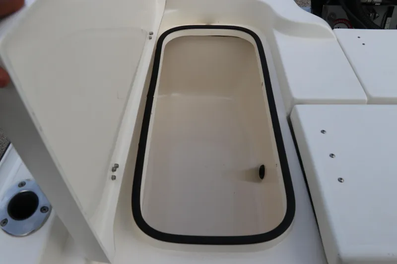 Slide: The Image of Open storage compartment on a 2018 ShearWater 25 LTZ boat, showcasing interior space. - 9
