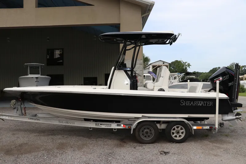 Slide: The Image of 2018 ShearWater 25 LTZ boat on trailer, parked outdoors. - 4