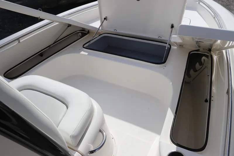 Slide: The Image of 2018 ShearWater 25 LTZ boat interior with open storage compartments and seating. - 38