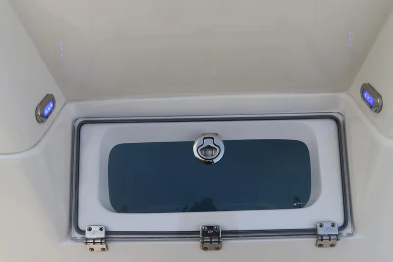 Slide: The Image of 2018 ShearWater 25 LTZ boat compartment with secure latch and LED lighting. - 17