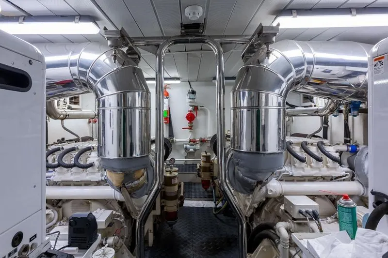 Slide: The Image of Engine room of 2000 Azimut 85 Ultimate yacht with polished metal pipes and machinery. - 21