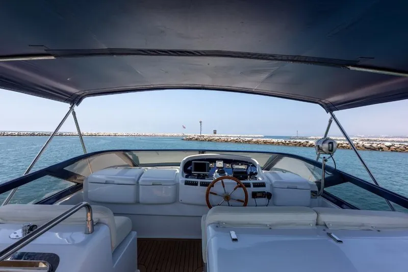 Slide: The Image of Cockpit view of 2000 Azimut 85 Ultimate yacht, featuring steering wheel and navigation equipment. - 18