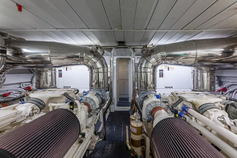 Slide: The Image of Engine room of 2000 Azimut 85 Ultimate yacht, featuring Kohler generators and polished exhaust systems. - 23