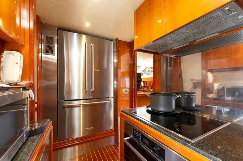 Slide: The Image of Luxurious kitchen in 2000 Azimut 85 Ultimate yacht with modern appliances and wooden cabinetry. - 54