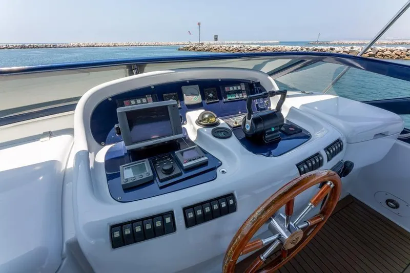 Slide: The Image of Cockpit of 2000 Azimut 85 Ultimate yacht with navigation controls and wooden steering wheel. - 17