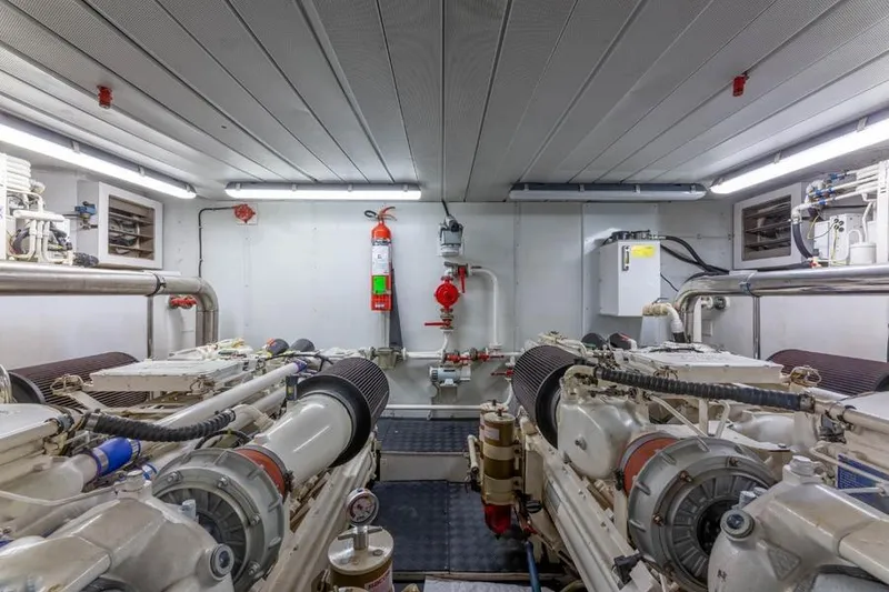 Slide: The Image of Engine room of 2000 Azimut 85 Ultimate yacht, featuring dual engines and safety equipment. - 24