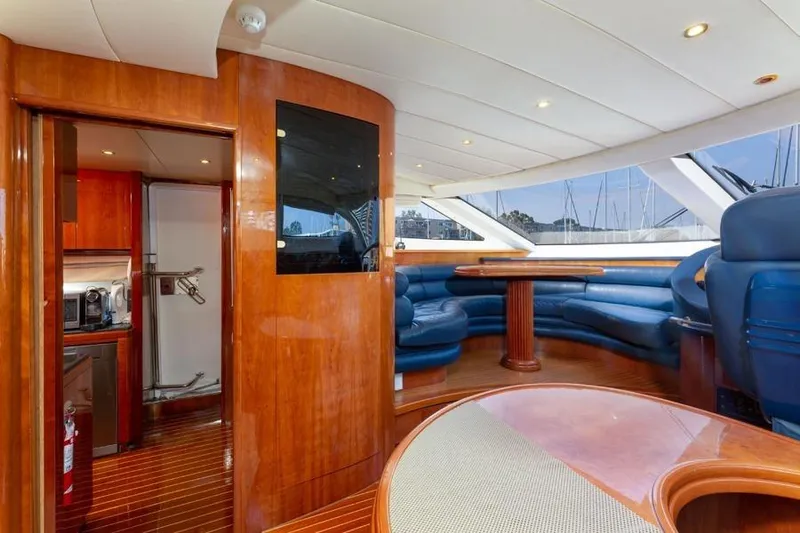 Slide: The Image of Luxurious interior of 2000 Azimut 85 Ultimate yacht with elegant wood finishes and blue seating. - 52