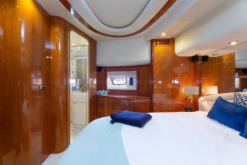 Slide: The Image of Luxurious bedroom interior of 2000 Azimut 85 Ultimate yacht with elegant wood paneling. - 43