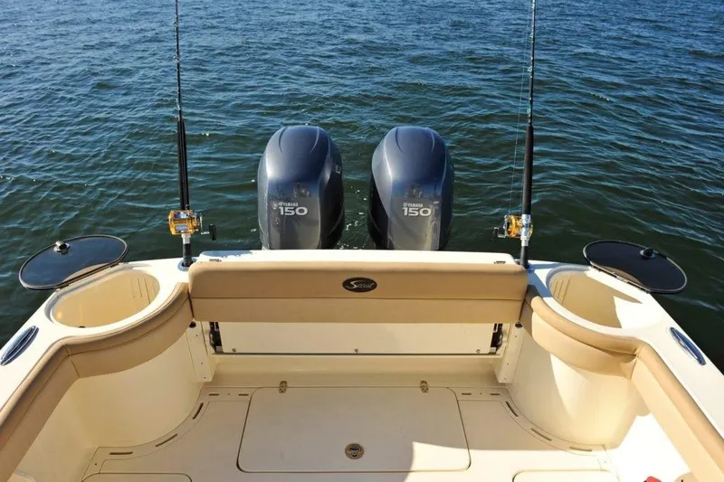 Slide: The Image of The image shows the stern of a Scout 277 LXF boat with two outboard engines. - 7