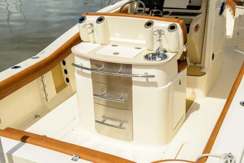 Slide: The Image of The image shows the cockpit of a 2020 Scout 277 LXF boat with sleek stainless steel features. - 3