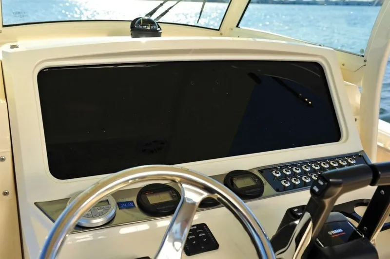 Slide: The Image of The image shows the cockpit of a 2020 Scout 277 LXF boat with a large screen. - 16
