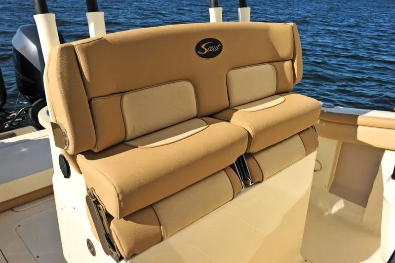 Slide: The Image of The 2020 Scout 277 LXF features a beige cushioned bench seat against a backdrop of blue water. - 12