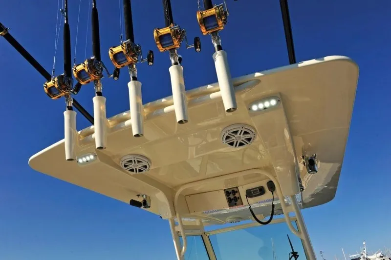 Slide: The Image of The image shows the rod holders and roof of a Scout 277 LXF boat. - 18