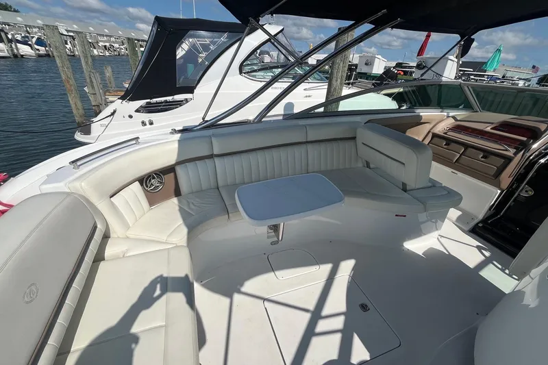 Slide: The Image of Luxurious 2008 Cobalt 323 boat interior with white seating and table, docked at marina. - 14