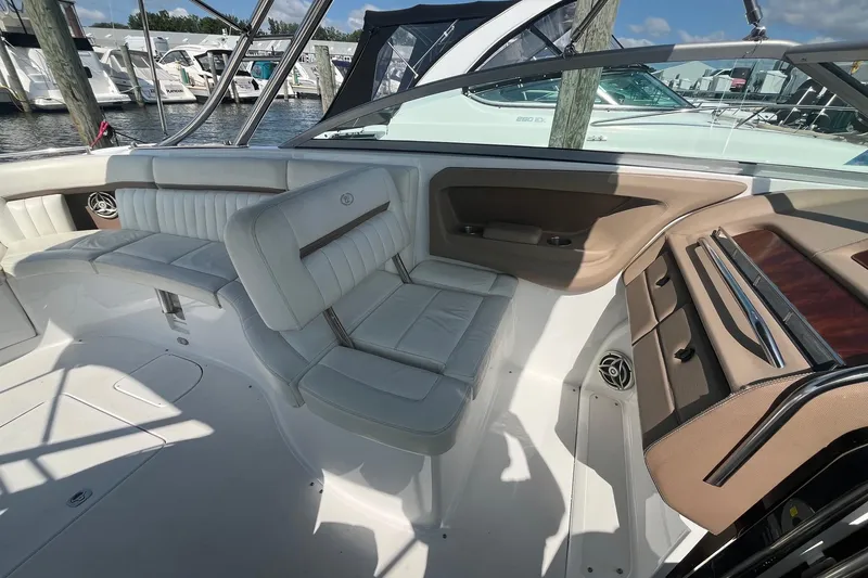 Slide: The Image of Interior of a 2008 Cobalt 323 boat with white leather seating and wood accents. - 16