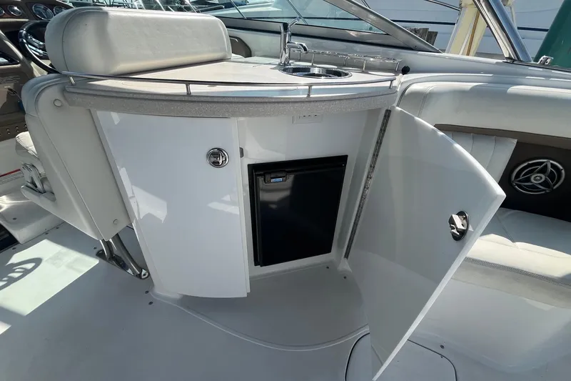 Slide: The Image of 2008 Cobalt 323 boat interior with open cabinet and mini fridge. - 15