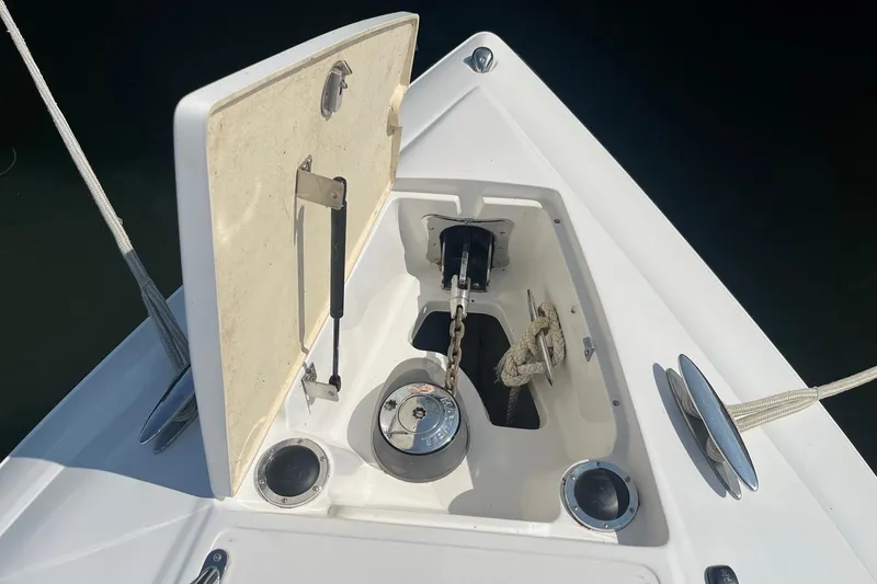 Slide: The Image of Anchor compartment of a 2008 Cobalt 323 boat, featuring a chain and winch system. - 3