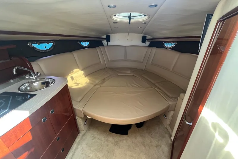 Slide: The Image of Luxurious interior of a 2008 Cobalt 323 boat with beige seating and kitchenette. - 26