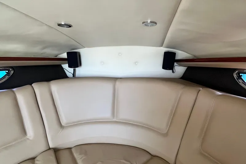 Slide: The Image of Interior of a 2008 Cobalt 323 boat with beige seating and speakers. - 35