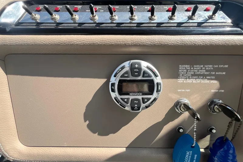 Slide: The Image of Control panel of a 2008 Cobalt 323 boat with Kenwood audio system and ignition keys. - 21