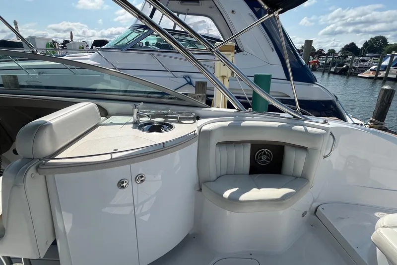 Slide: The Image of Interior of a 2008 Cobalt 323 boat with seating and sink, docked at a marina. - 12