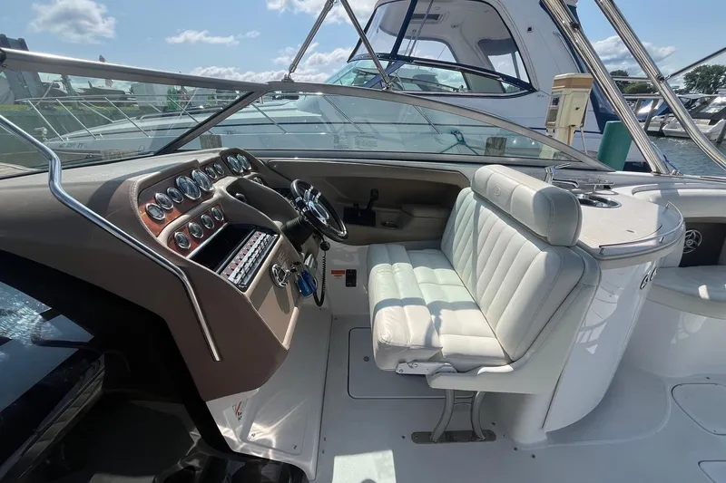Slide: The Image of 2008 Cobalt 323 boat cockpit with white seating and detailed control panel. - 20