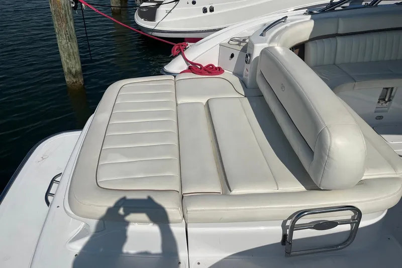 Slide: The Image of 2008 Cobalt 323 boat with white leather seating, docked by wooden posts. - 8