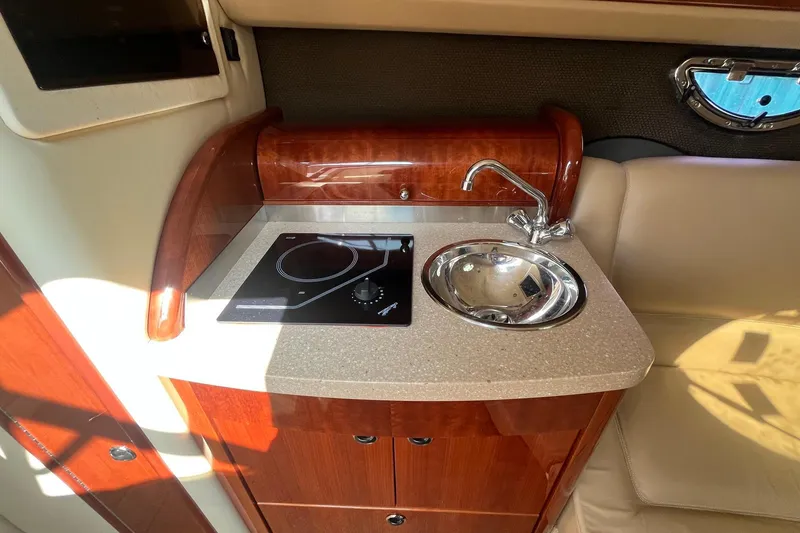 Slide: The Image of Compact kitchenette in a 2008 Cobalt 323 boat with sink and stove. - 30