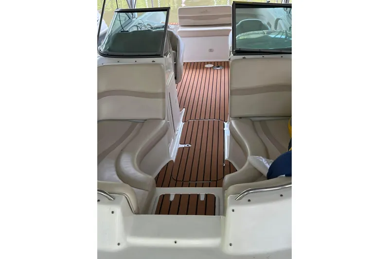 Slide: The Image of 2007 NauticStar 230 SL Sport Deck I/O interior with sleek seating and wood-style flooring. - 4