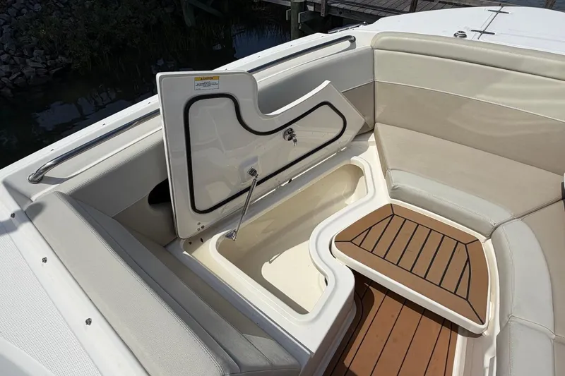 Slide: The Image of 2022 Boston Whaler 240 Vantage boat interior with open storage compartment and cushioned seating. - 12