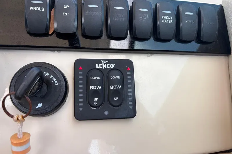 Slide: The Image of Control panel of a 2022 Boston Whaler 240 Vantage boat with Lenco trim tab switches. - 16