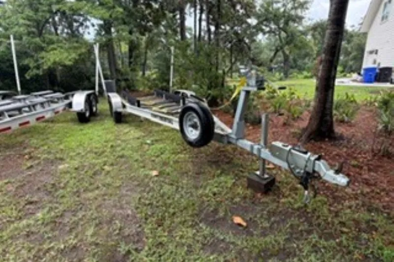 Slide: The Image of Trailer for 2022 Boston Whaler 240 Vantage on grassy area near trees. - 27