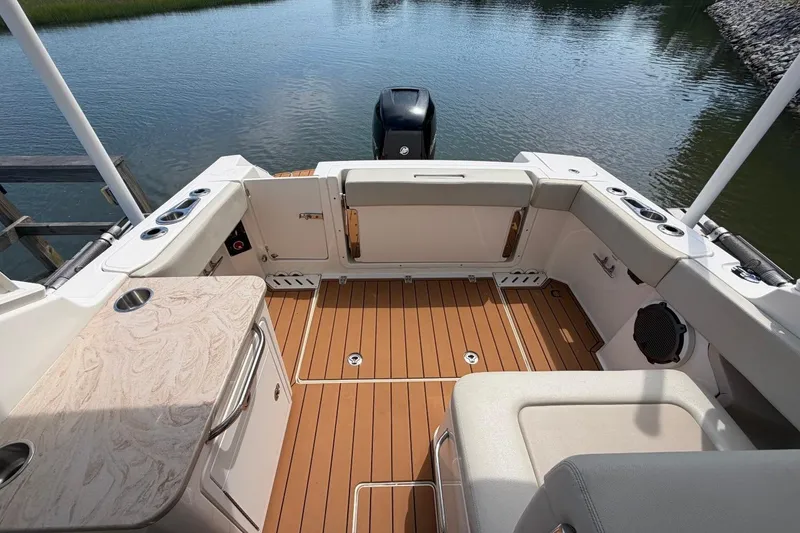 Slide: The Image of 2022 Boston Whaler 240 Vantage boat interior with teak flooring and seating area. - 22