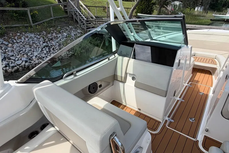 Slide: The Image of 2022 Boston Whaler 240 Vantage interior with sleek seating and wooden deck. - 17