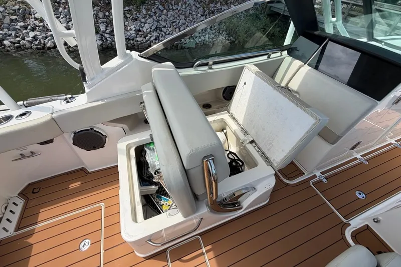 Slide: The Image of 2022 Boston Whaler 240 Vantage boat interior with open storage compartment and seating. - 21