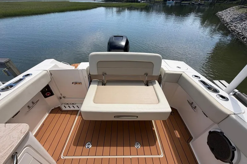 Slide: The Image of 2022 Boston Whaler 240 Vantage boat interior with seating and water view. - 23