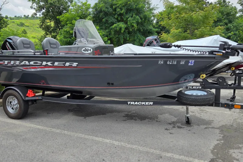 The Image of 2020 Tracker Pro Guide V-16 SC boat on trailer, parked outdoors. - 0