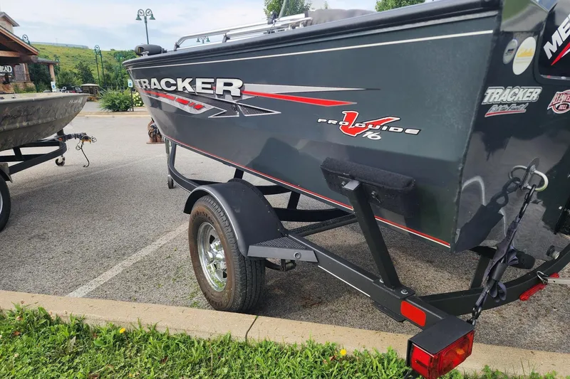 Slide: The Image of 2020 Tracker Pro Guide V-16 SC boat on trailer in parking lot. - 8