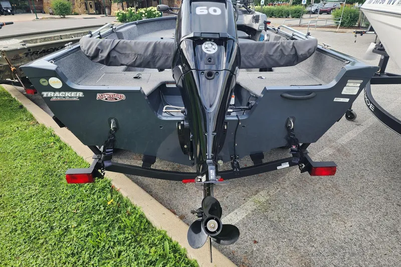 Slide: The Image of 2020 Tracker Pro Guide V-16 SC boat with outboard motor, parked on a trailer. - 6