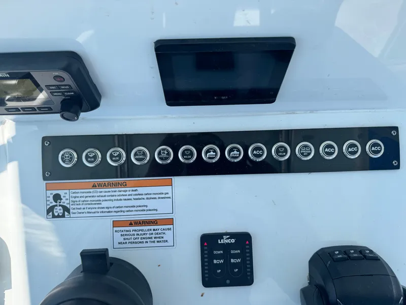 Slide: The Image of The image shows the dashboard of a Contender 24 Sport boat with various switches and displays. - 8