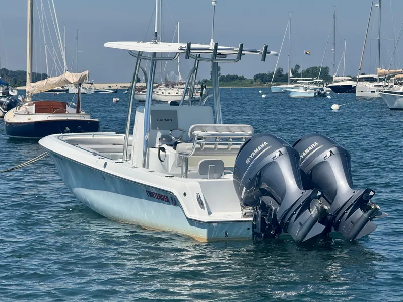 Slide: The Image of A 2024 Contender 24 Sport boat with twin Yamaha outboard engines, floating on the water. - 3