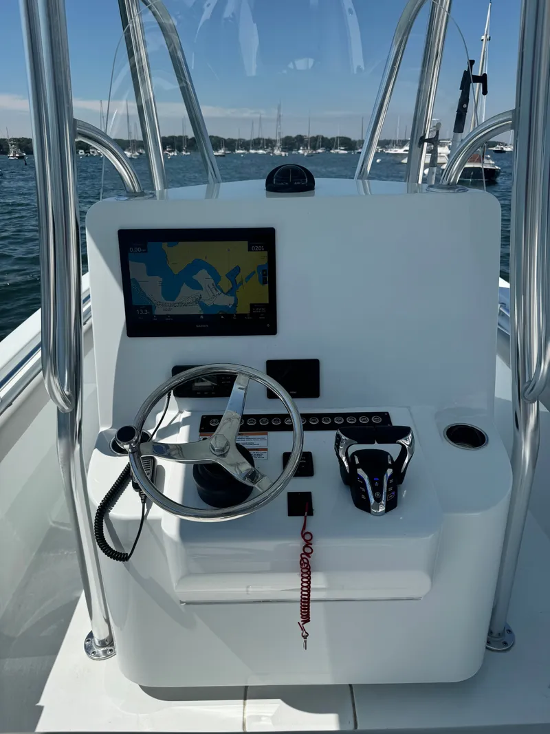 Slide: The Image of The image shows the helm of a 2024 Contender 24 Sport boat with a modern navigation system. - 7