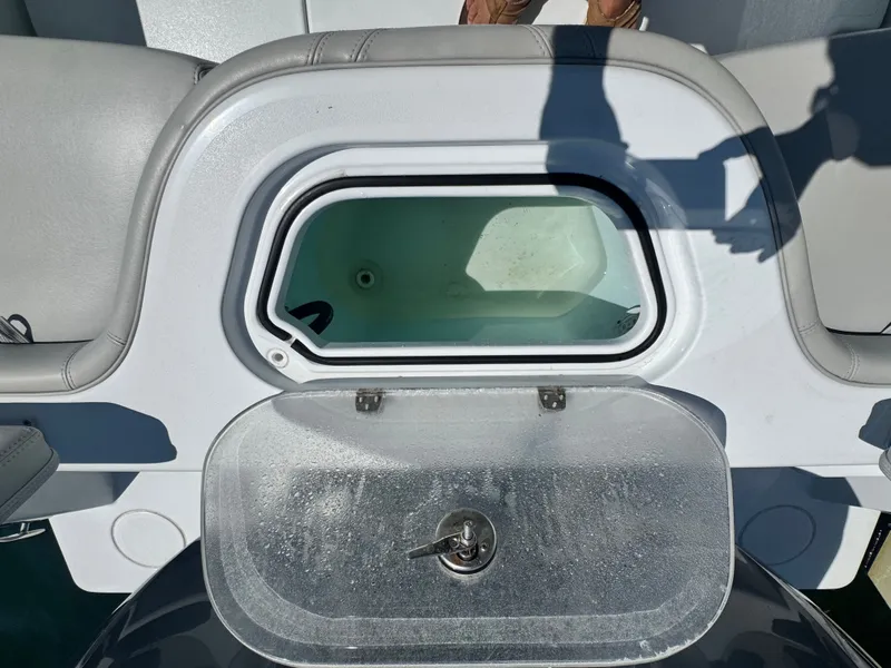 Slide: The Image of A livewell on a Contender 24 Sport boat, surrounded by gray upholstery. - 19