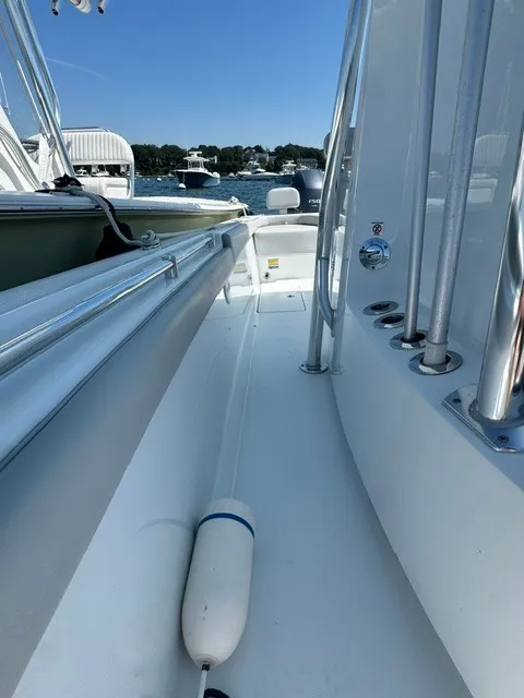 Slide: The Image of The image shows the deck of a 2024 Contender 24 Sport boat, with sleek lines and shiny metal railings. - 11