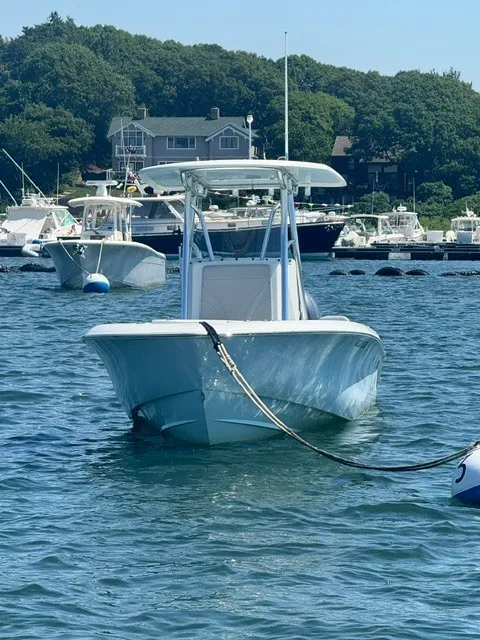 Slide: The Image of A 2024 Contender 24 Sport boat is on the water, surrounded by other boats and trees in the background. - 6