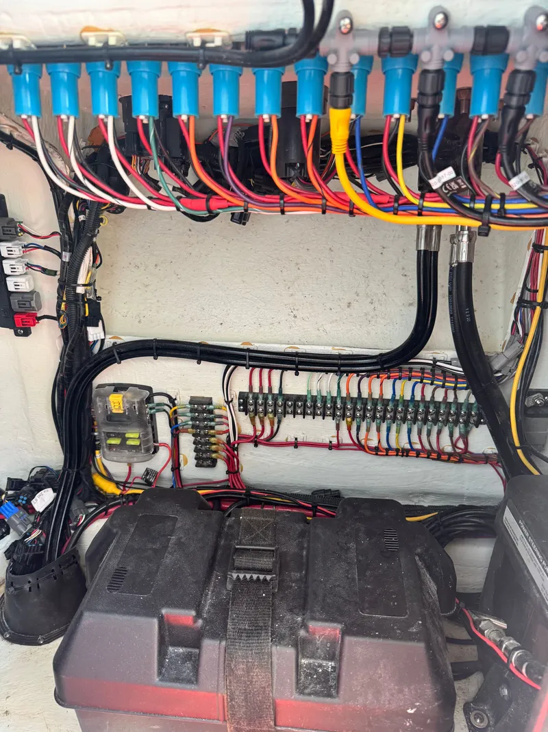 Slide: The Image of A view of the electrical system in a 2024 Contender 24 Sport boat with colorful wiring. - 21